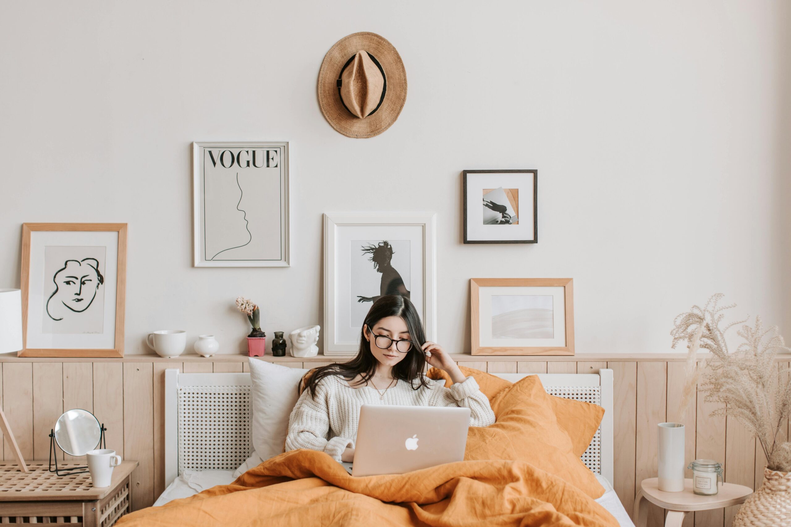 Woman Using Laptop In Bed